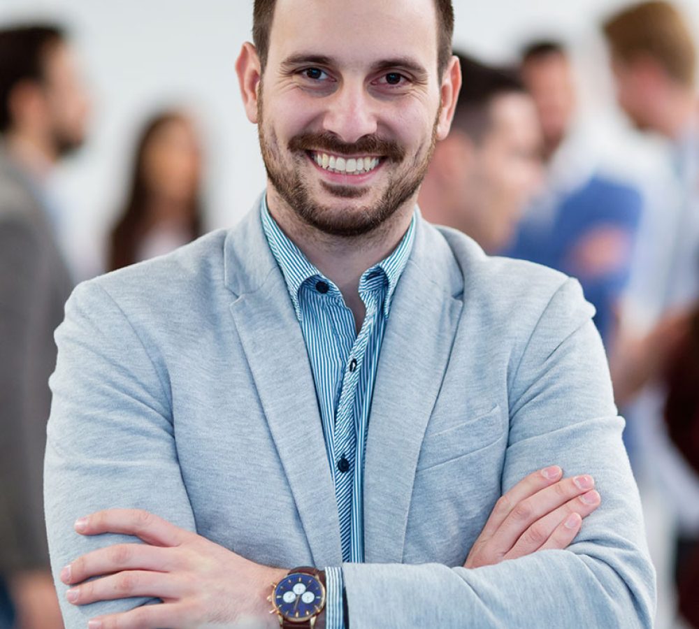group-picture-of-businessman-posing-in-office-ZKA6TFS.jpg